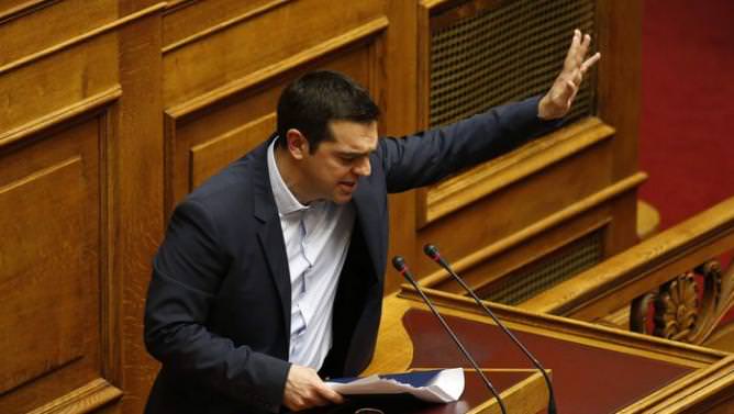 Greek Prime Minister Tsipras waves to lawmakers following his first major speech in parliament in Athens